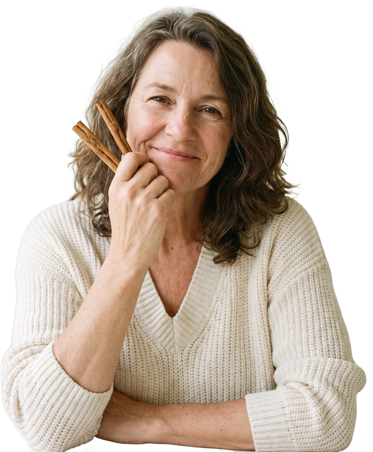 Smiling woman holding Ceylon cinnamon sticks
