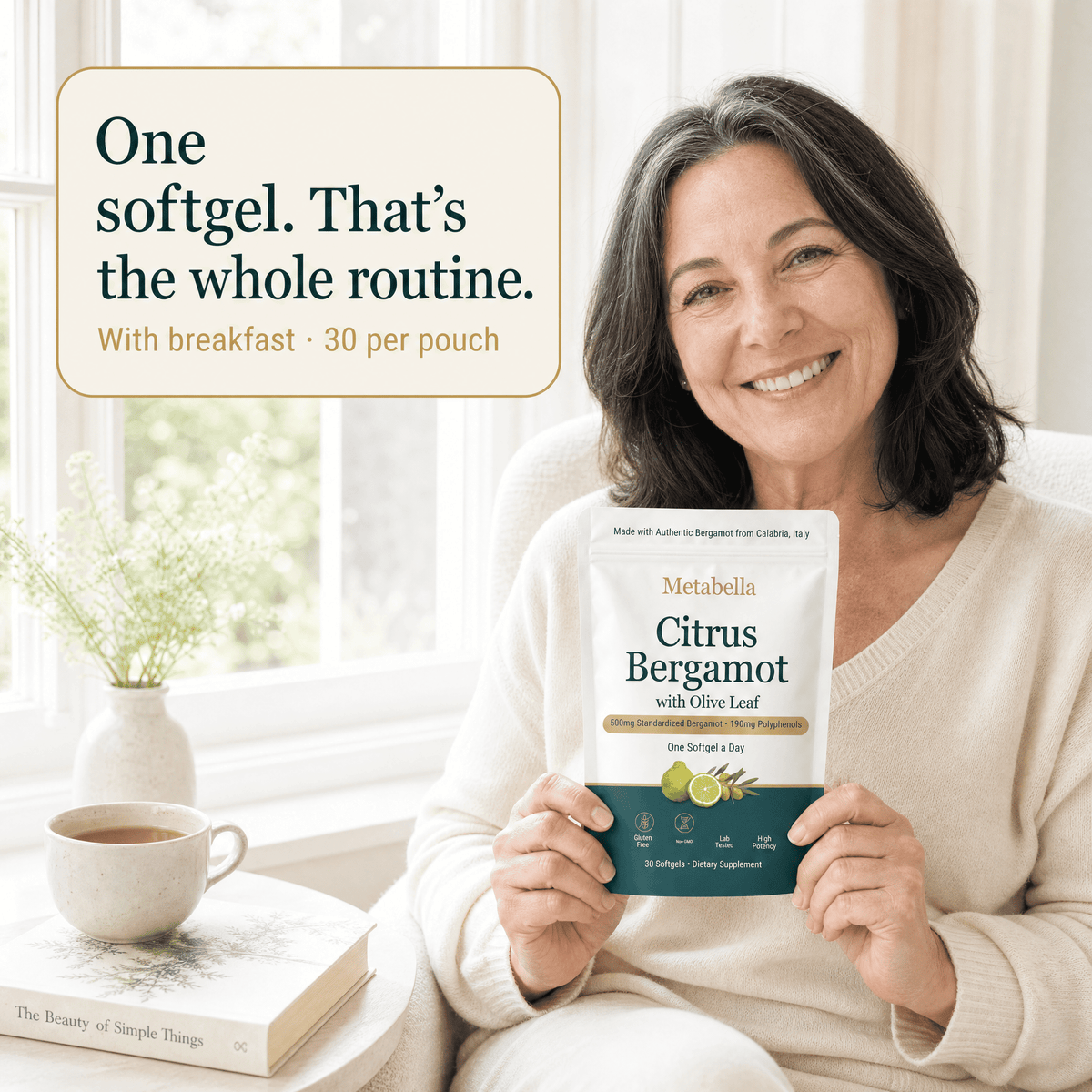 Smiling woman holding Metabella Citrus Bergamot pouch: one softgel a day with breakfast, 30 per pouch